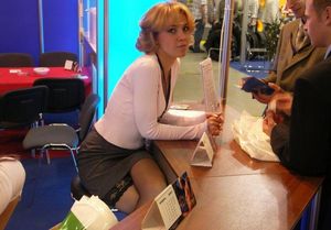 glimpse of her stocking behind the desk