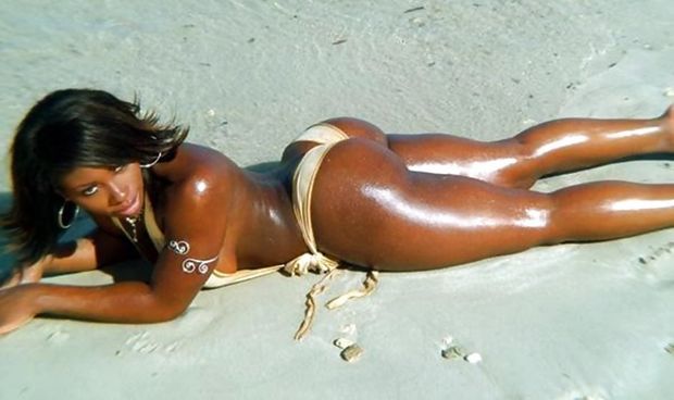 Ebony laying out on the beach showing off her big ass