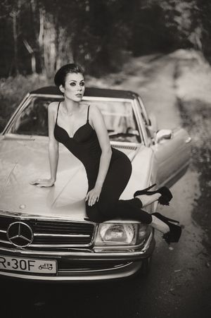 Elegant woman should always pose with sophisticated coupe.