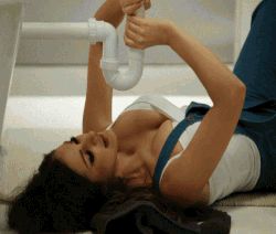 wrapping her hands around the plumbing
