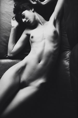 Petite brunette laying in bed