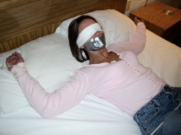 woman bound to bed, gagged and blindfolded