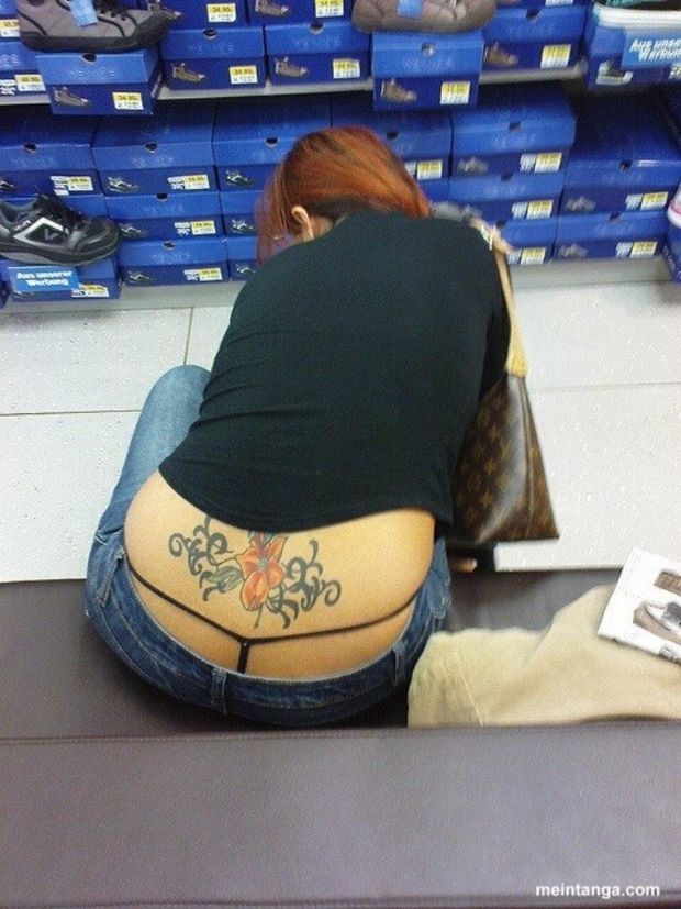 Black floss thong and tramp stamp peeking out while shopping for shoes