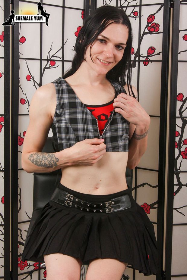 Cute Hung Schoolgirl Tranny Bathory Blaze shows her skinny teen body, perky tits and big cock wearing skirt and panties..