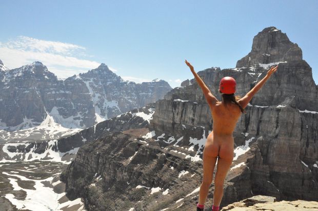 Girl with red helmet nude on mountain top