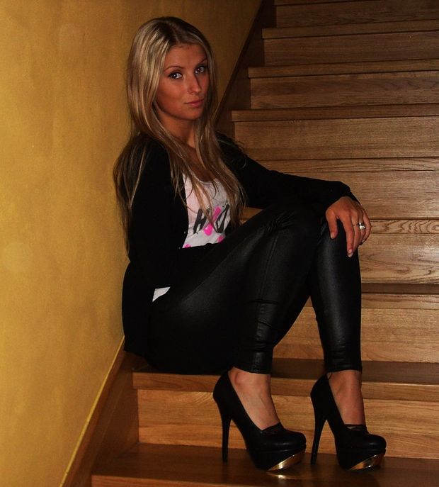 Blone amateur sitting on the stairs