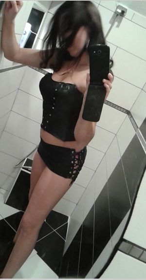 Selfie from a nightclub restroom. That girl definitely has a style. Hot leather outfit must draw all mens' attention in the club