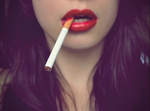 Lots of Red Lipstick and a dangling cigarette.