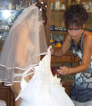 Getting her dress on.