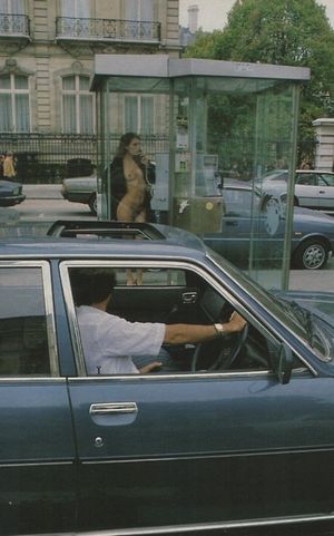 Using the pay phone and showing body to every passer by yo see