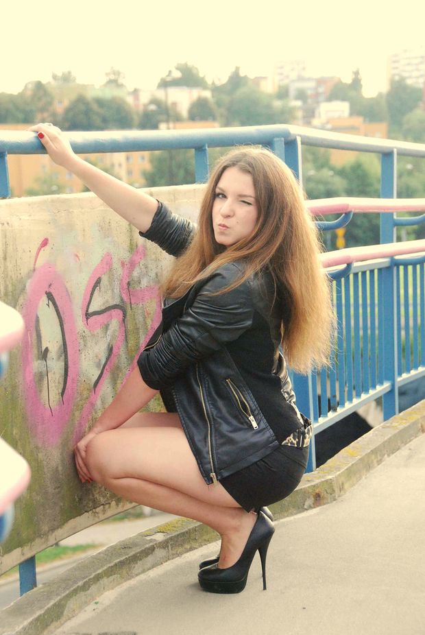 Joyful dark blonde on the bridge