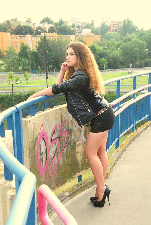 Cute brunette bimbo on a bridge