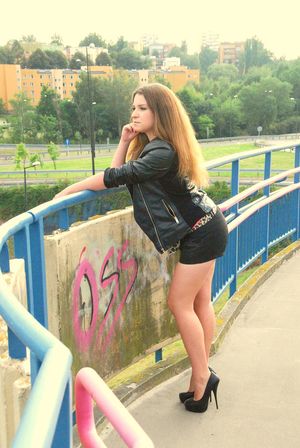 Cute brunette bimbo on a bridge