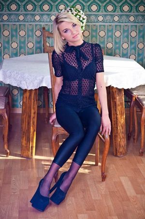 Blonde bimbo in see-through blouse.