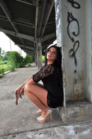 Kinky chick in short tight dress, posing for money, at least for now just posing