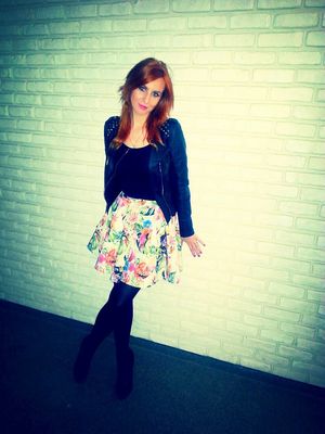 Pretty redhead standing by the wall