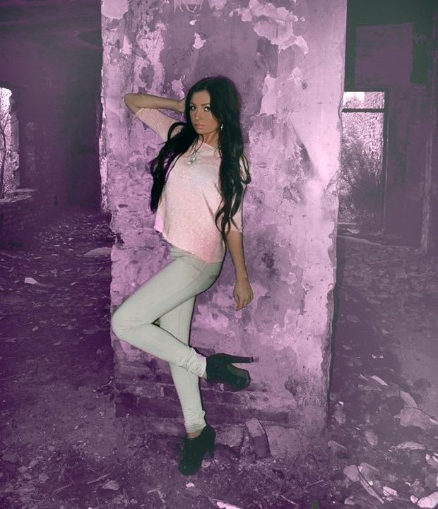 Hot dark hair bimbo posing in abandoned building