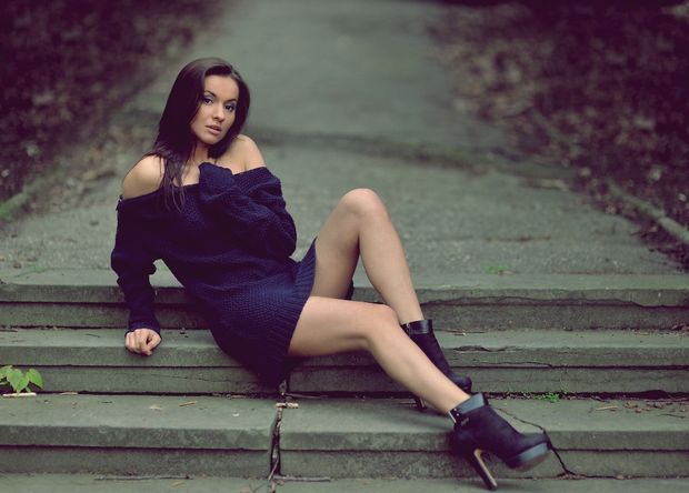Beautiful woman on the stairs in the park