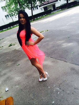 Dark hair bimbo in cute pink dress and white peeptoe heels outdoor