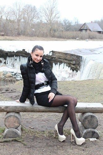 Brunette bimbo in short skirt and high heels