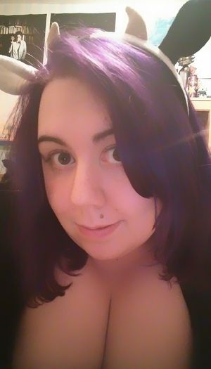 Hucow - A masked cow is milked at over a wooden rail