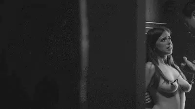 moaning when he pulls the chain clamped to her nipples