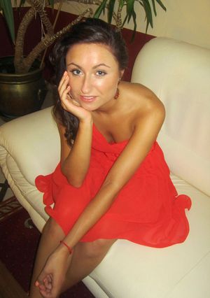 Tanned, braless party girl in red