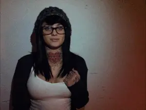 emo hipster babe with glasses flashing star tattoo boob