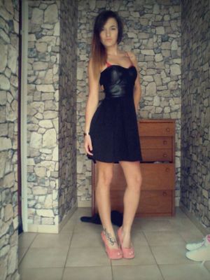 Brunette bimbo in pink heels and tight black mini dress