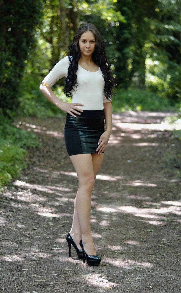 Outdoor chick in a black mini skirt, heels and white blouse