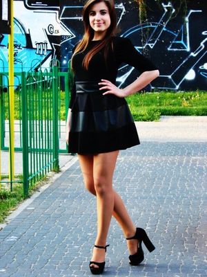 Hot chick outdoor in high heel sandals, short skirt and black blouse