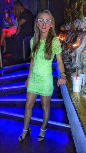 Party babe in glasses and neon colour dress