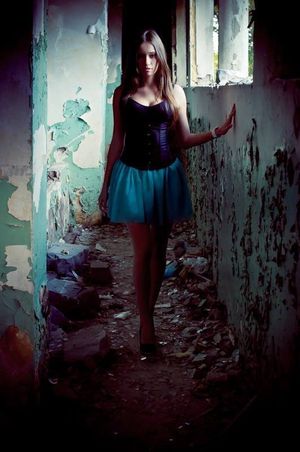 Hot girl in sexy outfit in abandoned building