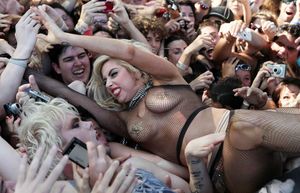 Lady Gaga crowd surfs and is groped.
