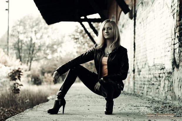 Young blonde in leather outfit outdoors