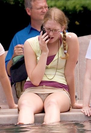 On the phone with panties showing in short skirt