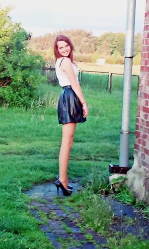 Country redhead chick in leather skirt and heels