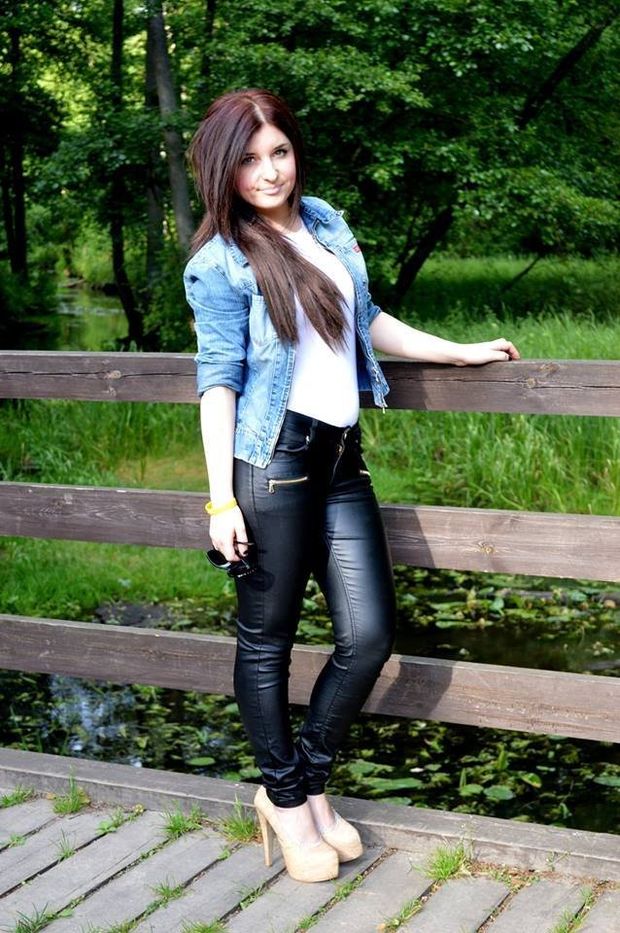 Brunette in leather black leggings outdoors