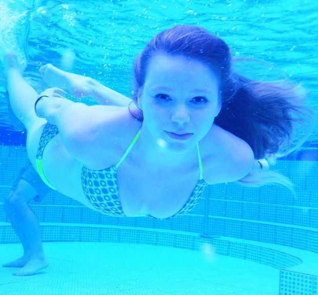 beautiful flat chested brunette swiming underwater