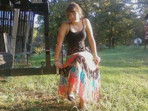 cute brunette sitting in tanktop and dress