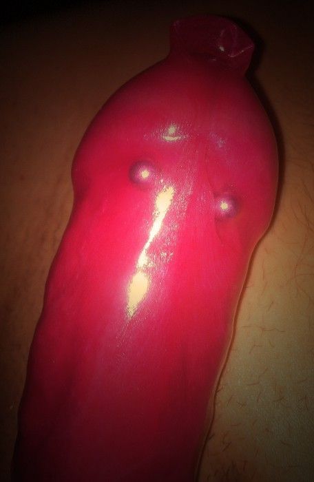 Condom over a cock with a frenum piercing