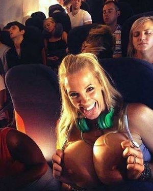 Bimbo MILF flashing on the plane