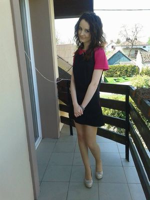 Shy brunette on the balcony