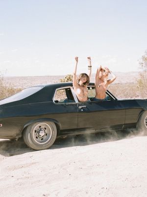 Two girls flashing out the window of car