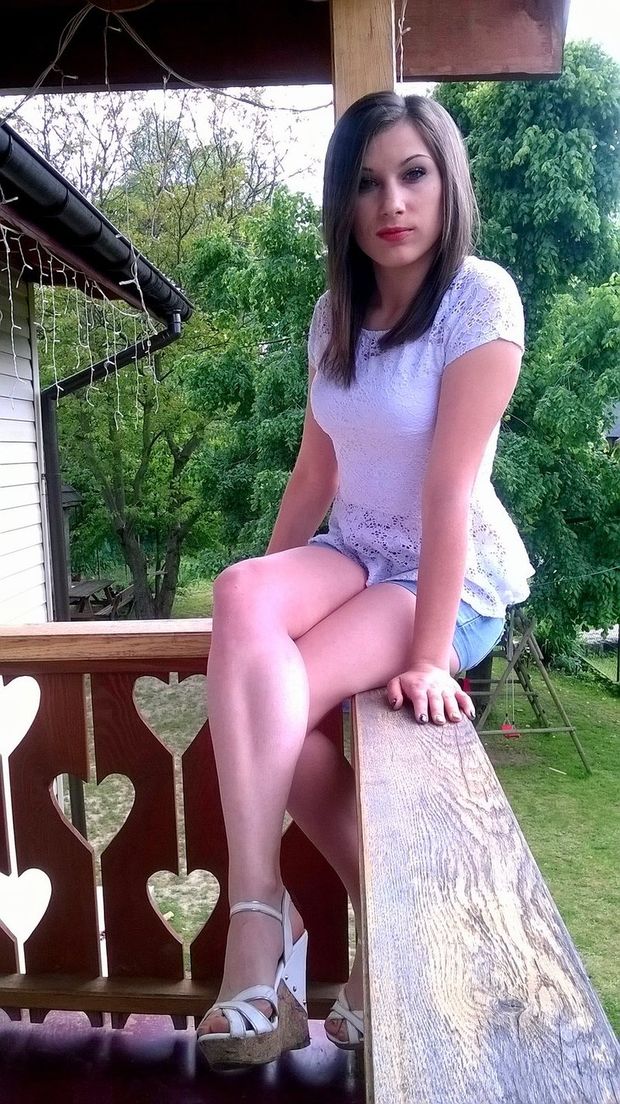 Young brunette sitting on the porch.