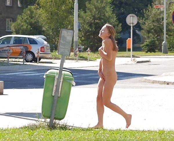 18+ blonde running along a street nude