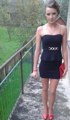 Young sexy chick going out in tight mini black dress and red peeptoe heels