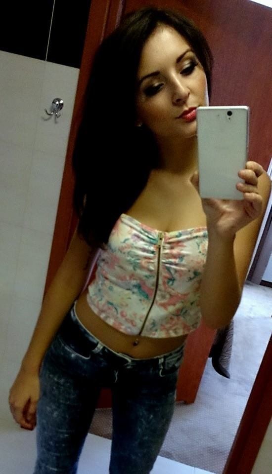 Dark hair babe taking a selfie in the restroom