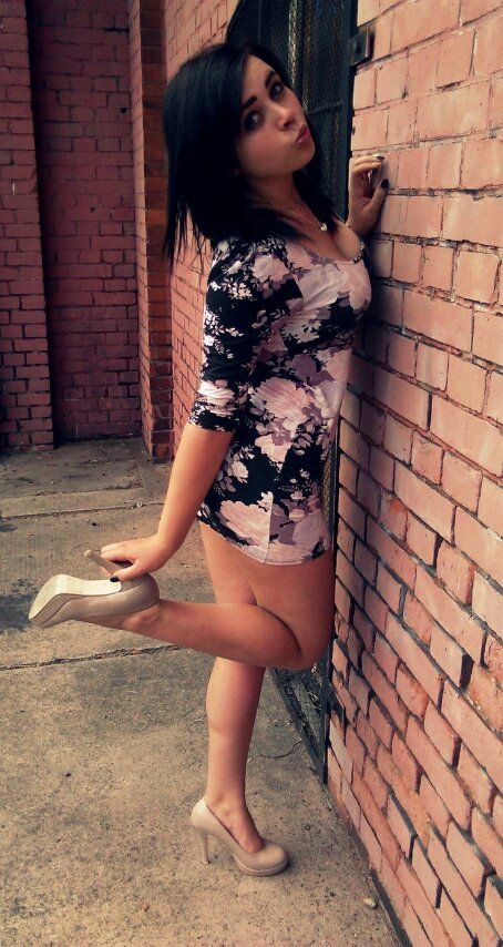Brunette wearing tight mini dress with duckface