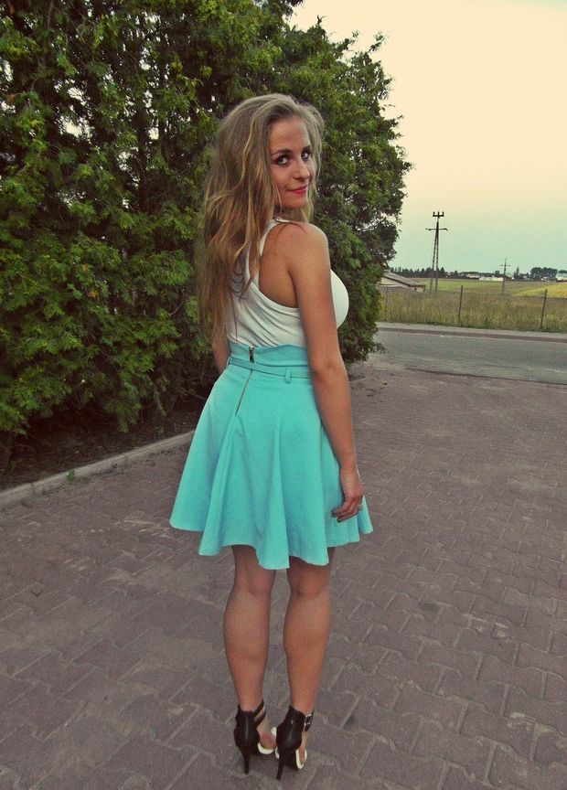 Busty blonde chick in mini skirt and high heels outdoors
